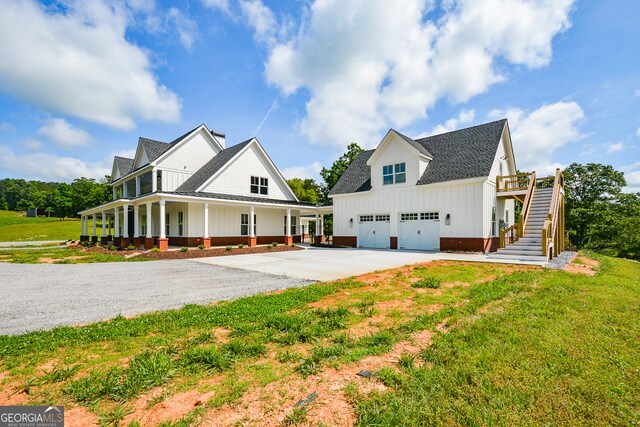 view of front of house with a front lawn, a garage, and a porch