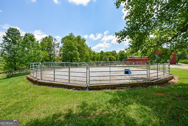 view of swimming pool featuring a yard and a rural view