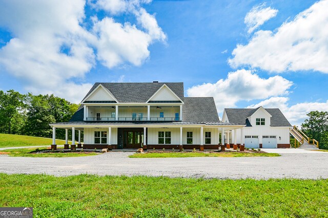 view of front of property featuring a garage, a front lawn, and a porch