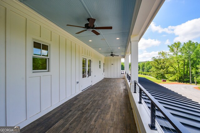 wooden terrace featuring ceiling fan