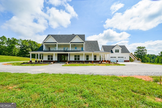 view of front of home featuring a front yard, a porch, and a garage