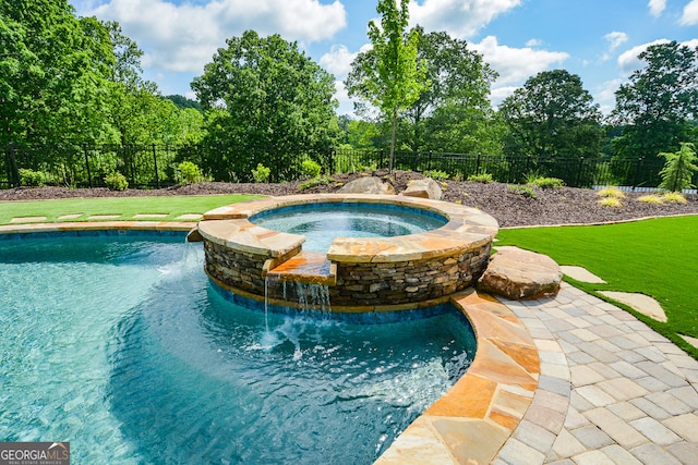 view of swimming pool with a yard, an in ground hot tub, and pool water feature