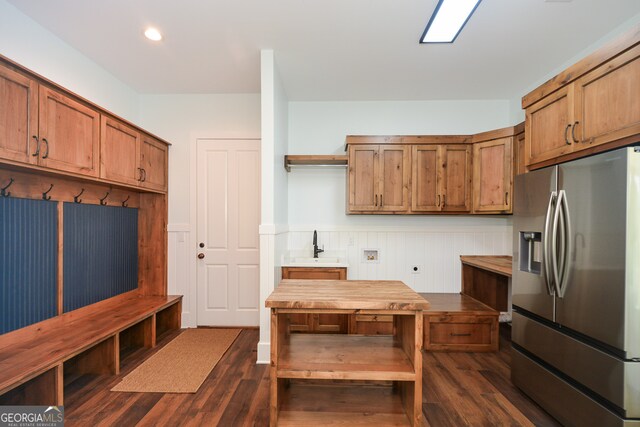 kitchen with dark hardwood / wood-style floors, sink, butcher block counters, and stainless steel fridge