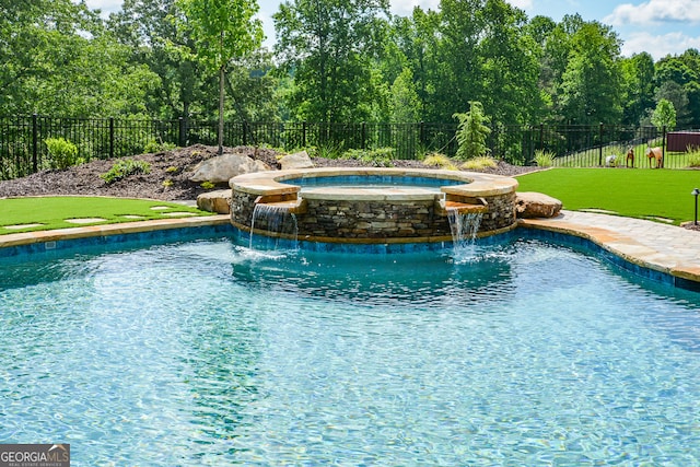 view of pool featuring a lawn, an in ground hot tub, and pool water feature