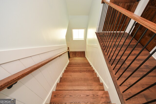 staircase with hardwood / wood-style floors