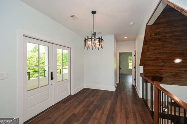 interior space with a notable chandelier and dark hardwood / wood-style flooring