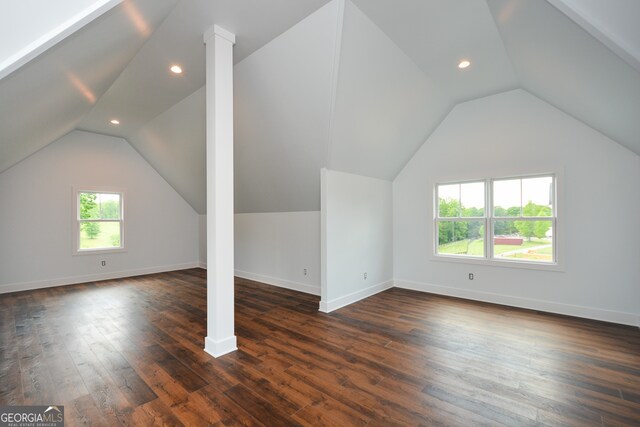 additional living space featuring dark hardwood / wood-style flooring and vaulted ceiling