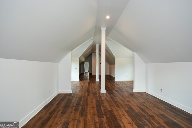 additional living space with dark hardwood / wood-style flooring and lofted ceiling