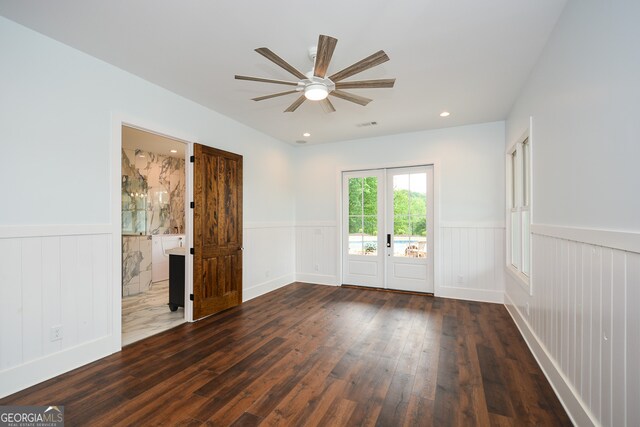 spare room featuring ceiling fan, dark hardwood / wood-style flooring, and french doors