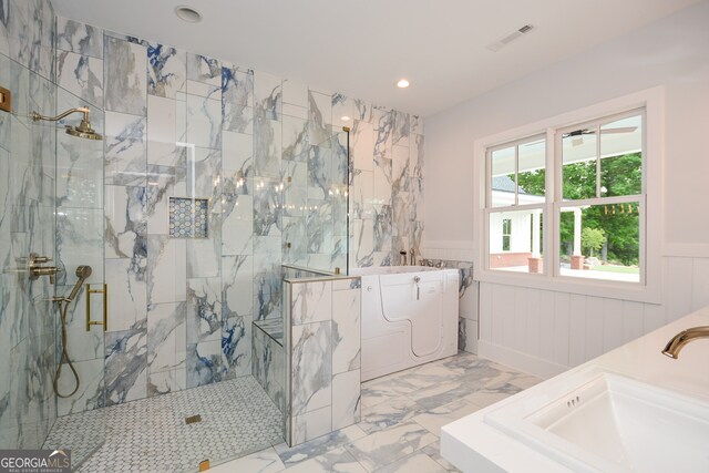 bathroom with tile flooring, separate shower and tub, and sink