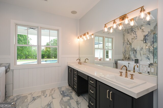 bathroom featuring tile flooring, dual sinks, and large vanity