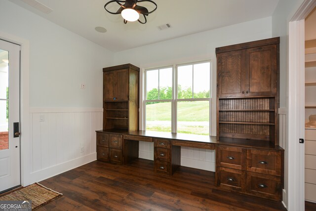 unfurnished office featuring dark wood-type flooring and ceiling fan