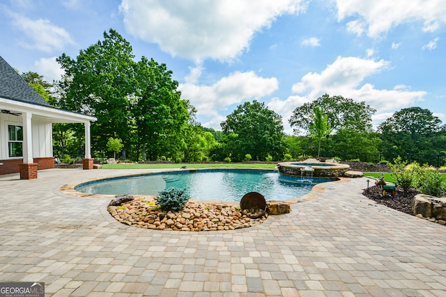 view of swimming pool with a patio and an in ground hot tub