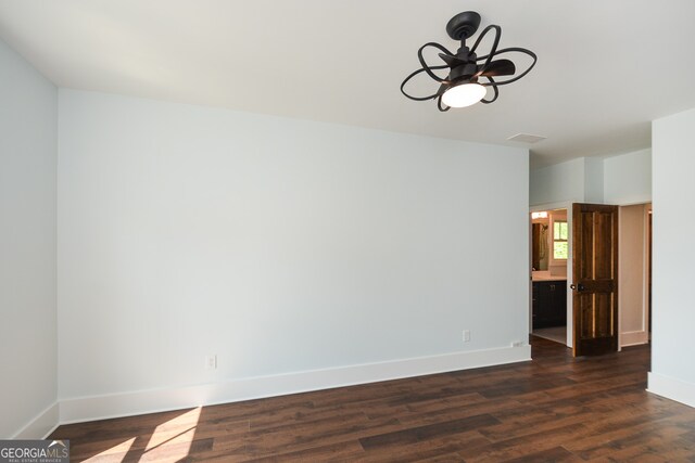 unfurnished room with dark wood-type flooring