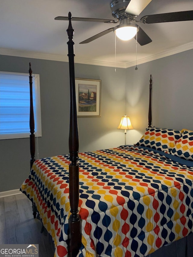 bedroom featuring ceiling fan, ornamental molding, and hardwood / wood-style flooring