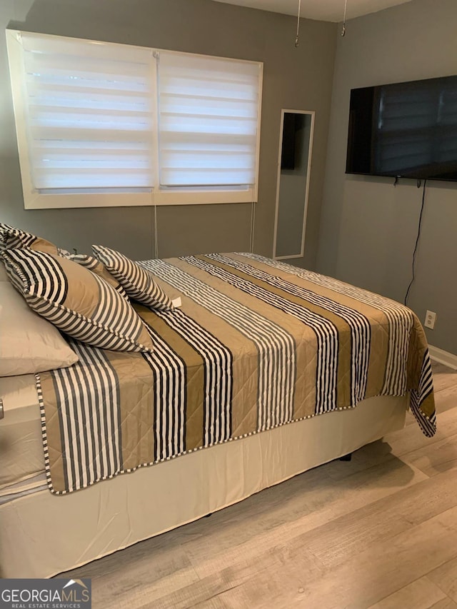 bedroom with light hardwood / wood-style flooring