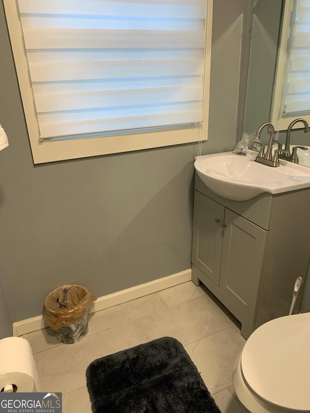 bathroom featuring vanity and toilet