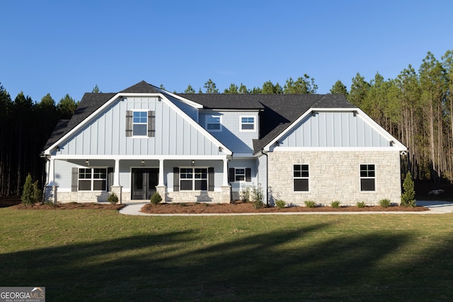 view of front of home with covered porch and a front yard