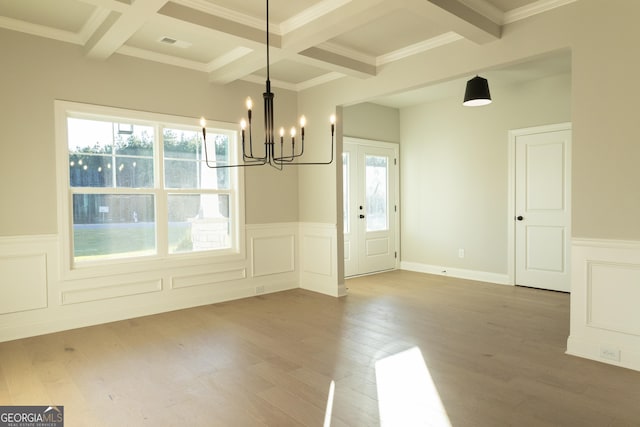 unfurnished dining area with beam ceiling, visible vents, and wood finished floors