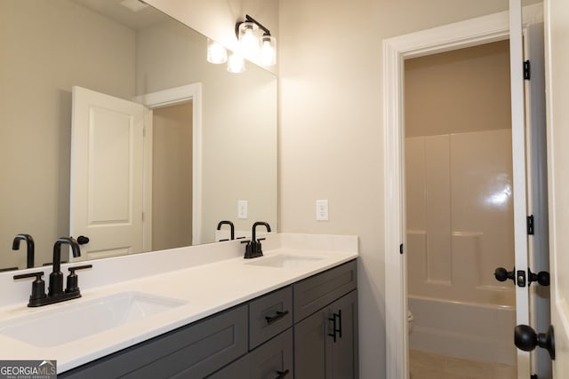 full bathroom with a sink, toilet, and double vanity