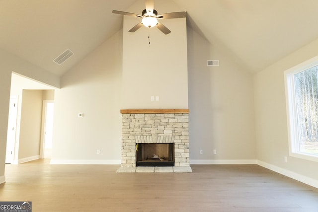 unfurnished living room featuring light wood-style floors, visible vents, a fireplace, and baseboards