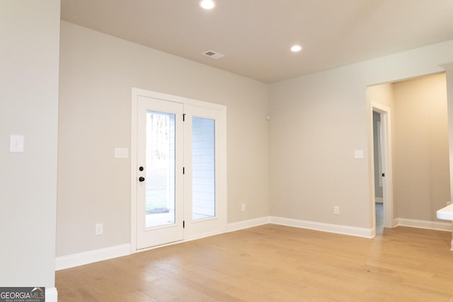 doorway to outside featuring baseboards, recessed lighting, visible vents, and light wood-style floors