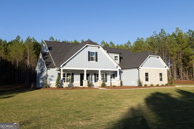 view of front of house featuring covered porch and a front yard