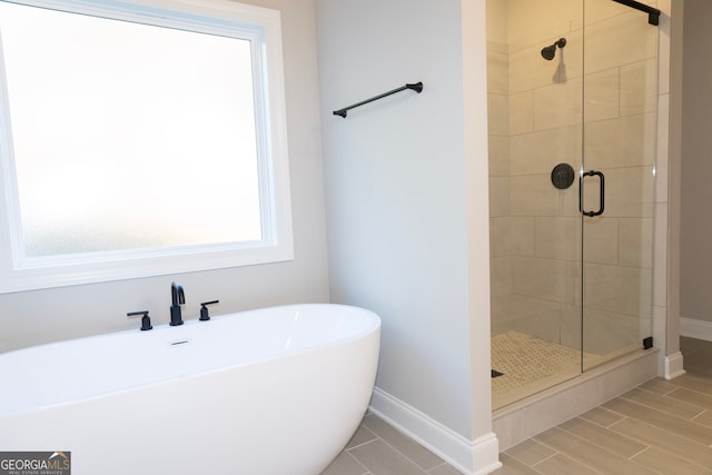 bathroom featuring separate shower and tub