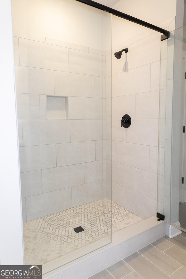 bathroom featuring a stall shower and tile patterned flooring