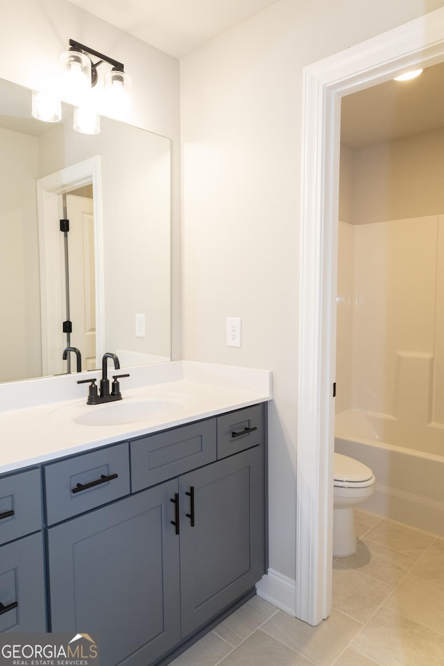 bathroom with bathing tub / shower combination, vanity, toilet, and tile patterned floors