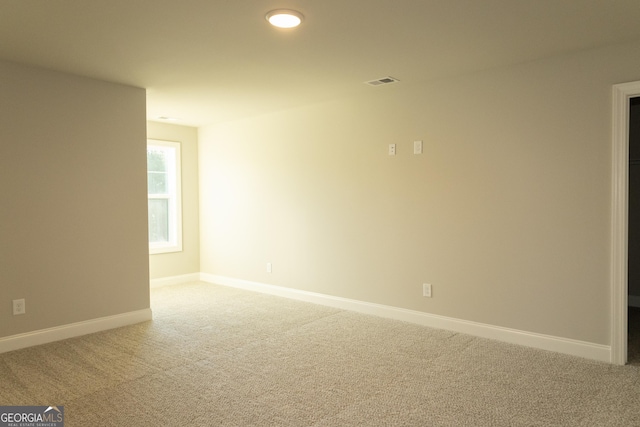 carpeted empty room with baseboards and visible vents