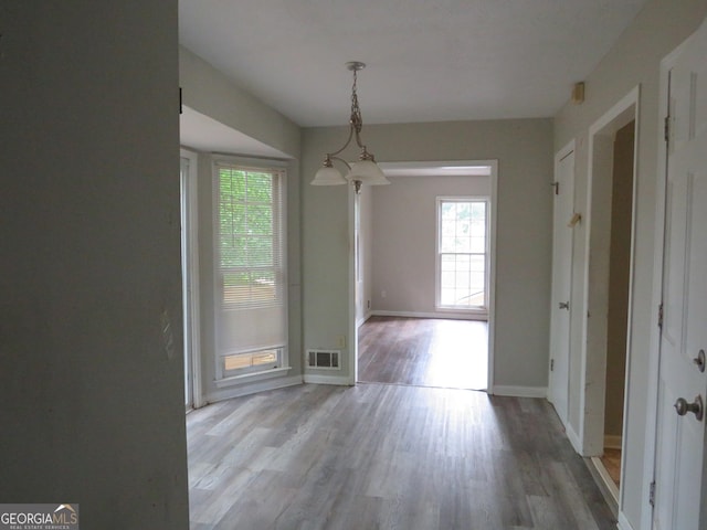 unfurnished dining area with light hardwood / wood-style floors