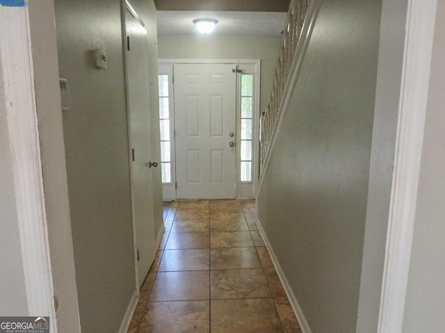 foyer entrance with dark tile patterned flooring