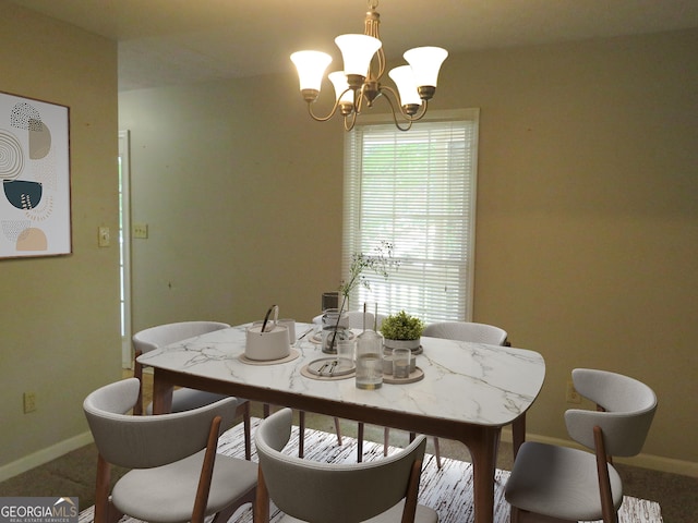 dining area featuring an inviting chandelier