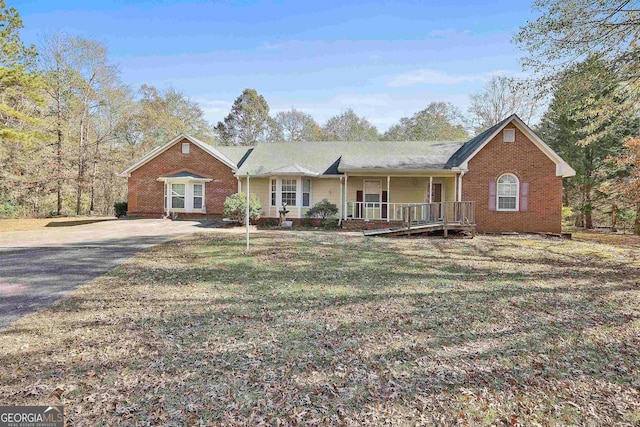 single story home with a front yard and covered porch