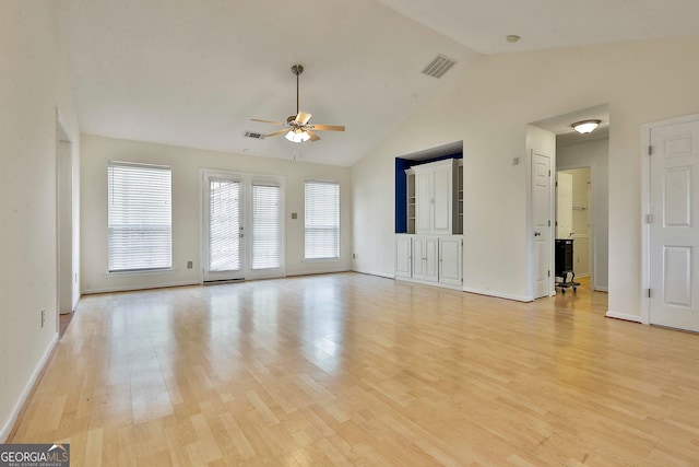 unfurnished living room with ceiling fan, light wood-type flooring, and lofted ceiling