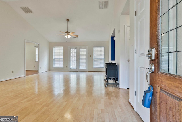 foyer with high vaulted ceiling, ceiling fan, and light hardwood / wood-style flooring