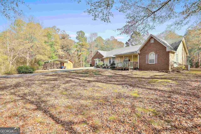 view of yard featuring a porch and a carport