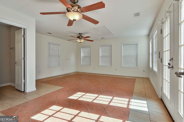 interior space with ceiling fan and light tile floors