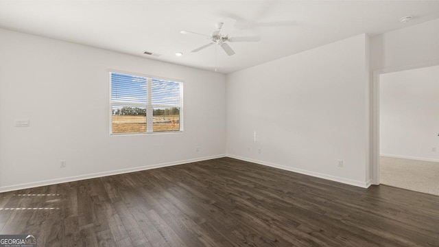 unfurnished room with ceiling fan and dark hardwood / wood-style flooring