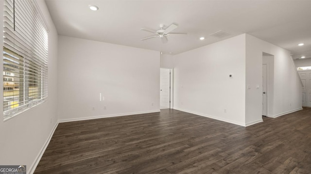 empty room with ceiling fan and dark wood-type flooring