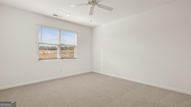 spare room featuring ceiling fan and carpet floors