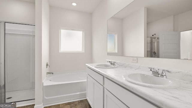 bathroom featuring vanity and shower with separate bathtub