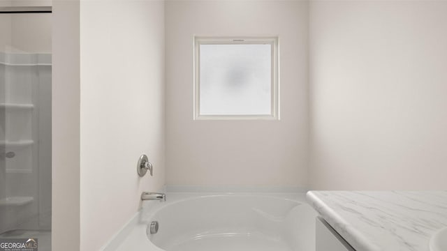 bathroom featuring a bathing tub and vanity