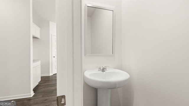 bathroom with hardwood / wood-style flooring and sink