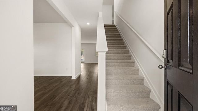 stairway featuring wood-type flooring