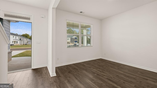 interior space with dark hardwood / wood-style floors and a wealth of natural light