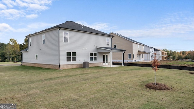 rear view of property with a patio, a lawn, and central air condition unit