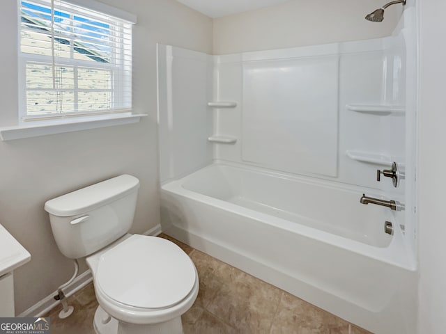 bathroom featuring shower / bath combination, toilet, and tile floors