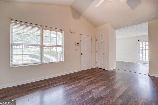 empty room featuring dark hardwood / wood-style flooring, ceiling fan, and lofted ceiling